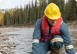A hardhat-clad Shell employee inspecting carbon
